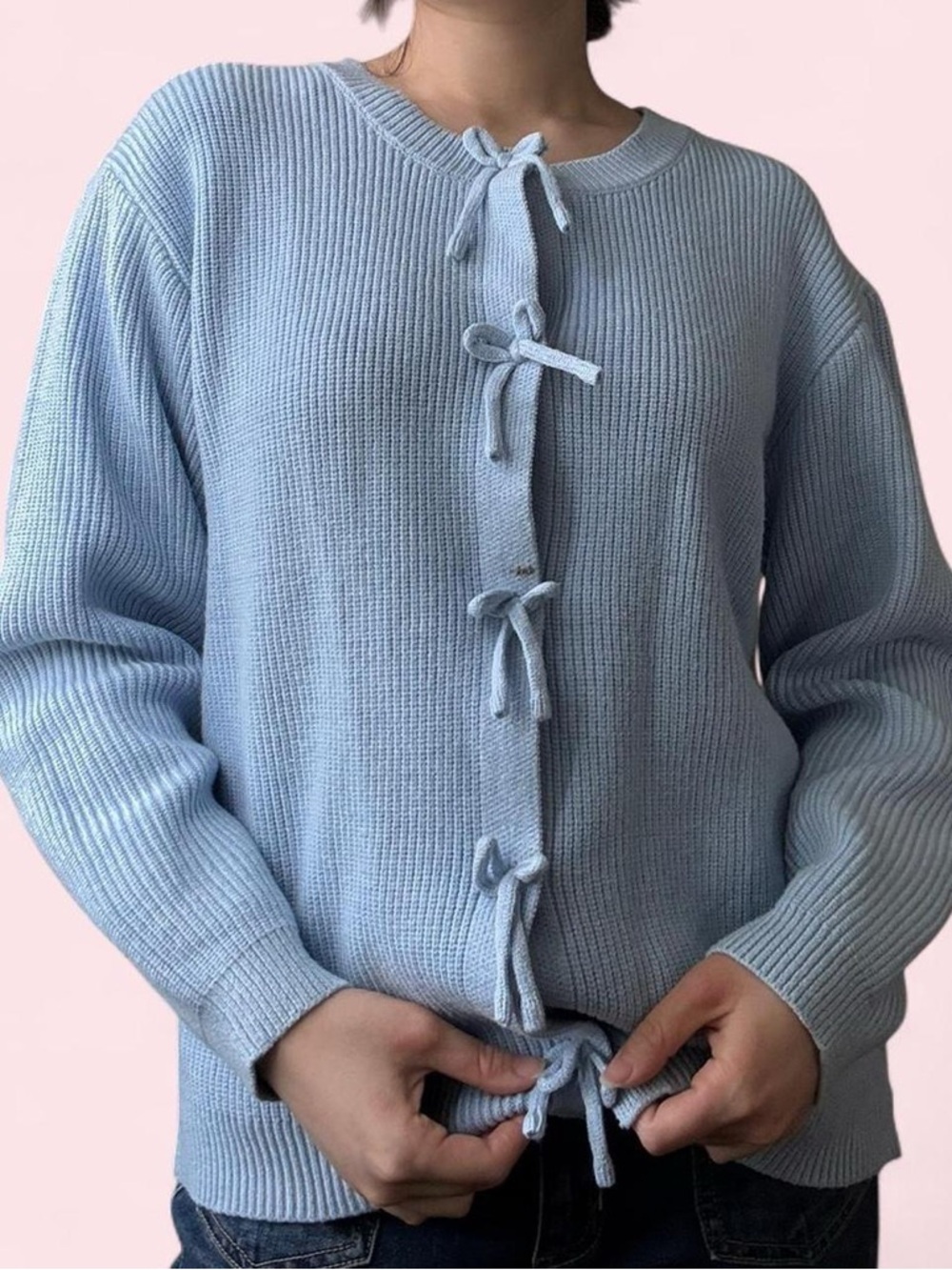 Blue knit sweater with bow tie buttons